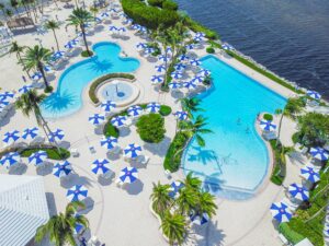 A pool with many blue and white umbrellas