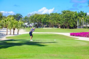 A man is playing golf on the green